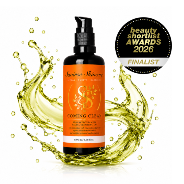 Saoirse Skincare Coming Clean facial cleansing oil bottle with a gold oil splash around it and a Beauty Shortlist Awards 2026 Finalist badge in the corner, white background, product shot.
