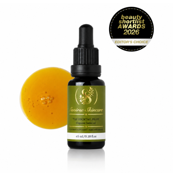 Bottle of Saoirse Skincare The Cocktail Feast organic facial oil with an orange slice beside it and an Editor's Choice badge (Beauty Shortlist 2026).