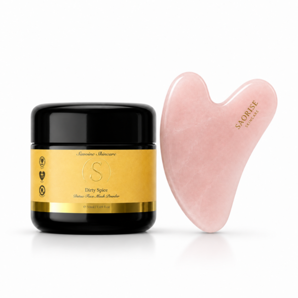 Jars of Savoine Skincare Detox Face Mask Powder labeled Dirty Spice beside a pink heart-shaped stone tool (gua sha) on white background